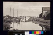 [Harbor townscape with bridge, boats and buildings]