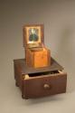 [Daguerreotype portrait of a young man, mounted in the lid of a small wooden sewing box.]