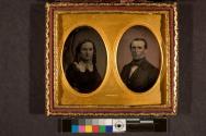 [Head and shoulders portrait of man and woman, oval openings in mat]
