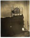 [Night time view of "Diamond Tires" sign on top of Hotel Fuller]