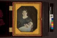 [Woman holding sleepy baby]