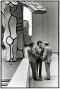 [Three men under sculpture]