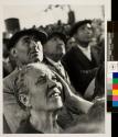 [Faces of people looking up]