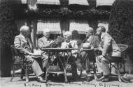 Adolph Ochs, George Eastman, Thomas Edison, General John Pershing, and Owen Young seated at a table during the Kodacolor Party in Eastman's garden