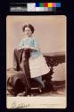 [Young girl with curly hair and pink bows]