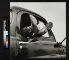 Truck driver [with cowboy boots sticking out of truck window], Vernon, Texas