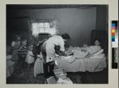 Midwife making a post-natal check, Hazard, Kentucky, 1956