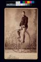[Man on high wheel bicycle]