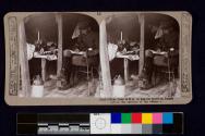 Staff Officer from G.H.Q. in dug-out studying details before the opening of our offense
