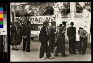 [Men looking at information board on the street in Barcelona]