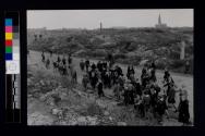 Schoolchildren from a secondary school left standing on the edge of the ghetto, pass through acres of rubble, all that is left of the homes of Warsaw's Jewish population