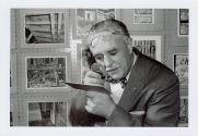 Harris Tuttle examining photograph