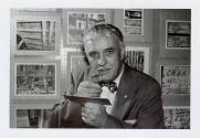 Harris Tuttle examining photograph