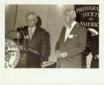 Harris Tuttle and unidentified man at podium for Photographic Society of America