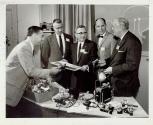 Harris Tuttle and men with photographic products
