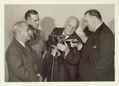 Harris Tuttle showing men movie camera