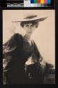 [Olga De Meyer, seated, large hat]