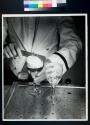 [Schaefer Beer, bartender leveling foam on glass of beer]