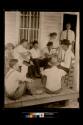 Front Porch of Fred O. Scroggs Store, men sitting on a chair