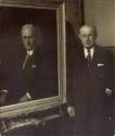 Dr. Chapman beside portrait of George Eastman
