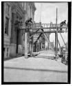Men working on porte cochere on Kodak Office building designed by J. Foster Warner