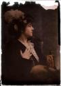 [Woman wearing hat with ostrich feather]