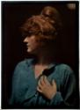 [Red haired woman wearing blue-green wrap]