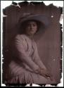 [Seated woman weating picture hat and suit]