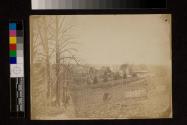 View of house, farm buildings, and fences.