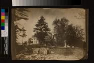 [Landscape with white house, stone wall with door]
