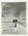 [James Sibley Watson Jr. on balcony with birdcage at 11 Prince Street, Rochester NY]