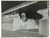 [Young woman in midi-blouse on deck of yacht with Kodak Bull's Eye or Eureka Camera]