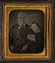 [Woman in bonnet with child holding cased photograph]