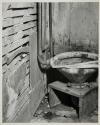 [Toilet on wooden stand]