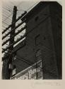 [Brick architecture through powerlines]