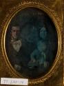 [Family portrait (father, mother, child on lap)]