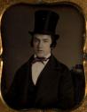 [Young man wearing top hat]