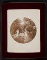 [Lawn with statue and plant stand]