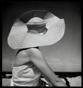 [On the beach - woman in large hat]