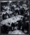 [People around tables in banquet room]