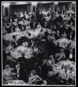 [People around tables in banquet room]