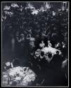 [People around tables and dancing in banquet room]