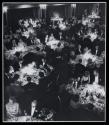 [People around tables in banquet room]