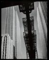 Rockefeller Center, seen from 6th Ave, reflected in a window pane