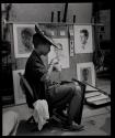 [Sidewalk portraitist, waiting for clients]