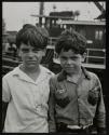 Lower East Side Kids on a Brooklyn dock, harbor tugs in background