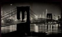[Brooklyn Bridge at night, with Downtown Manhattan in back]