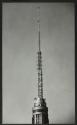 Workmen on aerial of Empire State building