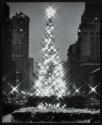 [Christmas tree in front of Rockefeller Center at night]