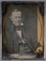 [Man in formal suit]